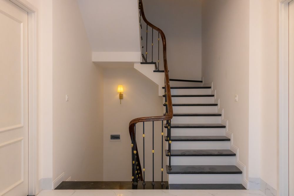 Modern staircase with wooden handrail
